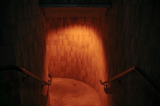 Dimly lit stairwell with warm orange light creating a mysterious atmosphere.