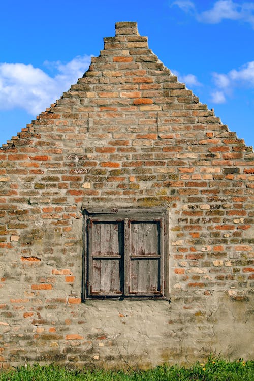 Exterior of an Old Brick House with a Wooden Window Frame 