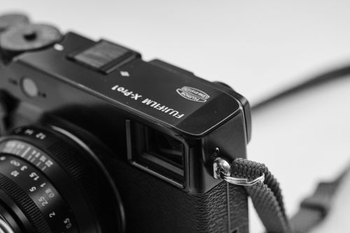 Free Detailed close-up of a Fujifilm X-Pro1 camera showcasing the body and lens in monochrome. Stock Photo