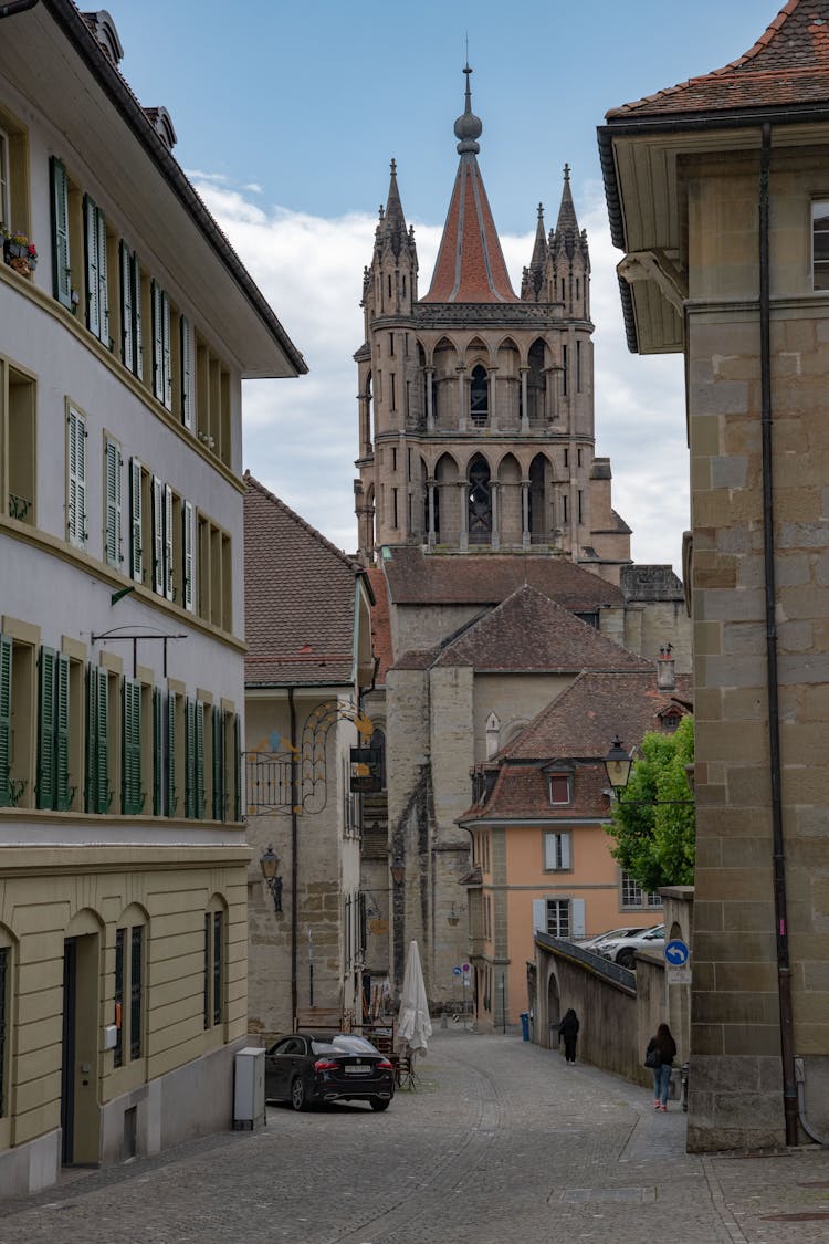 Tower Of Lausanne Cathedral Behind Street