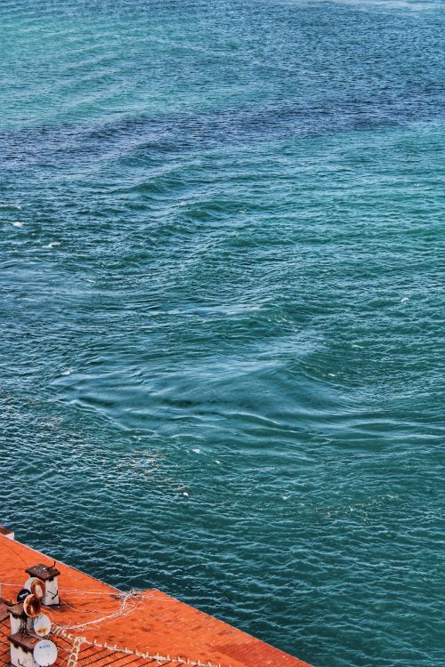 Free High angle view of the ocean waves with part of a rusty ship deck, providing ample copy space. Stock Photo