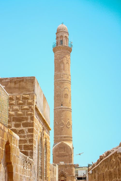 Free A stunning 13th-century minaret showcasing Ottoman architecture under a clear blue sky. Stock Photo