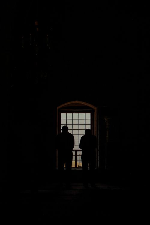 Silhouette of Men Standing in Front of a Window · Free Stock Photo