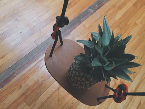 Pineapple on Brown Wooden Rack