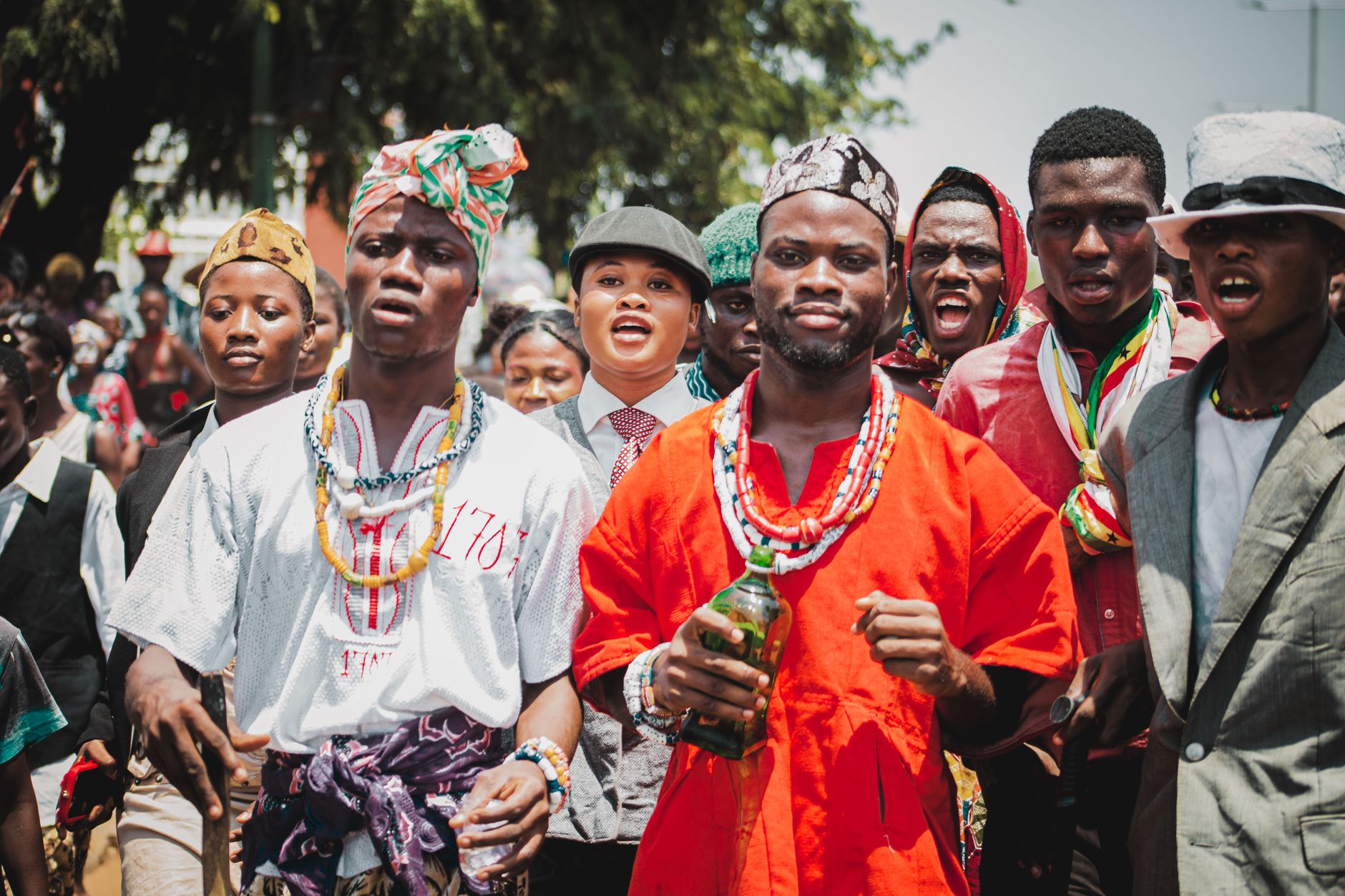 Colorful parade showcasing traditional attire and lively expressions in Accra, Ghana.