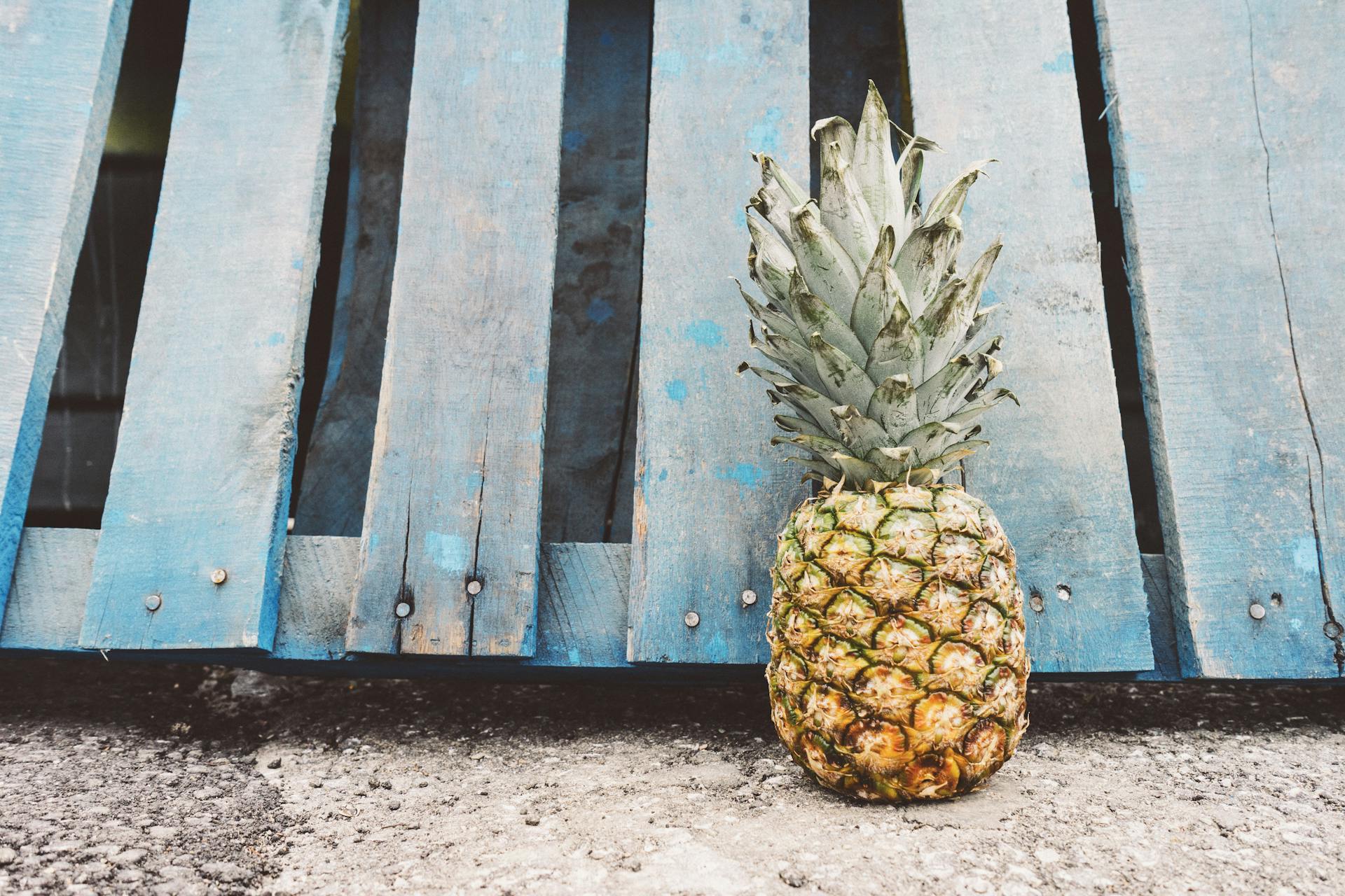 Yellow Pineapple Fruit Beside Blue Wooden Pallet