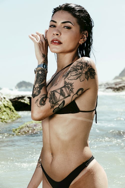 Free Photo of a Woman Wearing a Bikini, with a Tattoo on an Arm Stock Photo