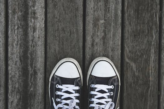 Black and White Sneakers on Grey Wooden Wood