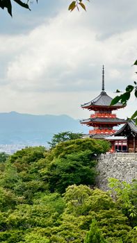 Serene view of the iconic Kiyomizu-dera Temple nestled in the lush greenery of Kyoto, Japan.