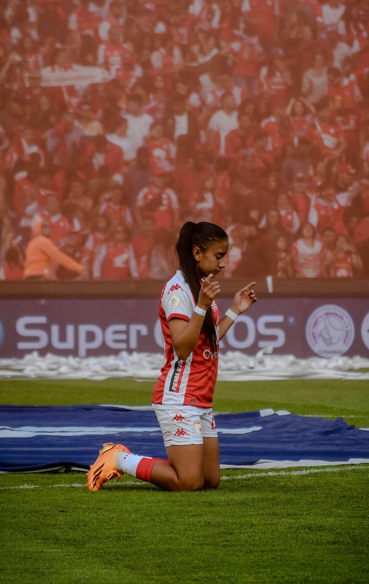 Football Player Praying On Stadium