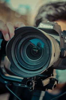 Detailed close-up of a DSLR camera lens highlighting its intricate design, perfect for technology and photography concepts.