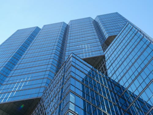 Low Angle Shot of a Modern Skyscraper under a Clear, Blue Sky 