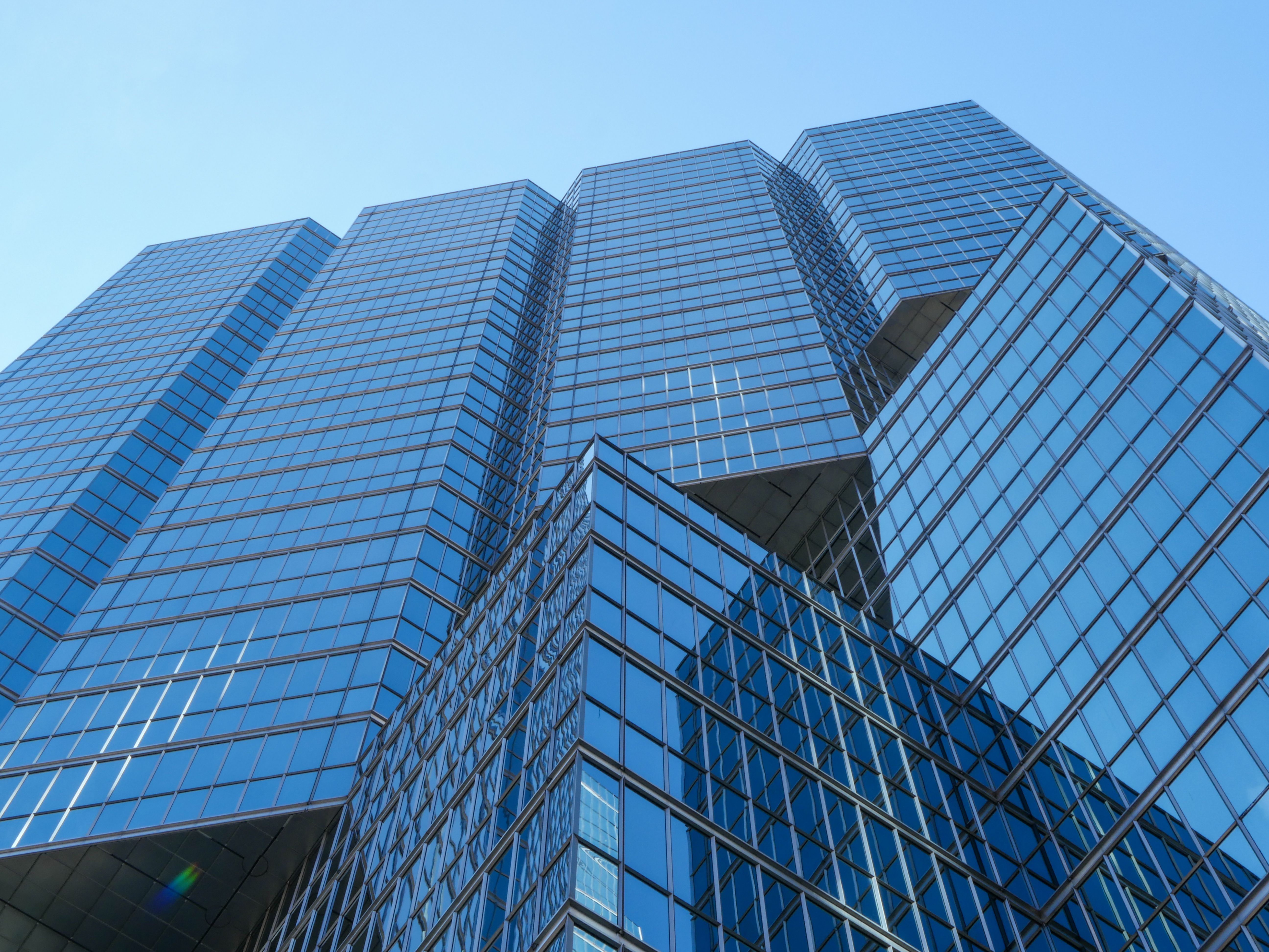 Low Angle Shot of a Modern Skyscraper under a Clear, Blue Sky · Free ...