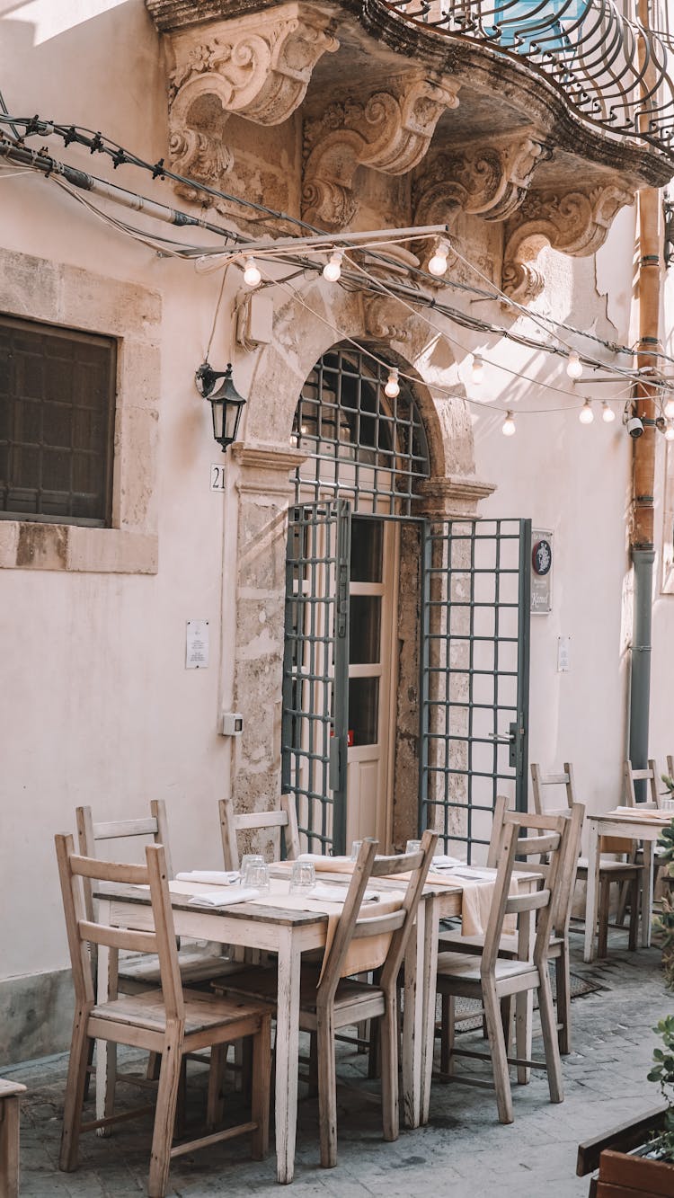 Tables Outside Of A Restaurant In A Historical Building