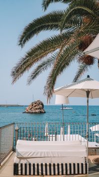 Enjoy a scenic view of the sea from a cozy terrace in Cefalù, Sicily, perfect for a summer vacation.