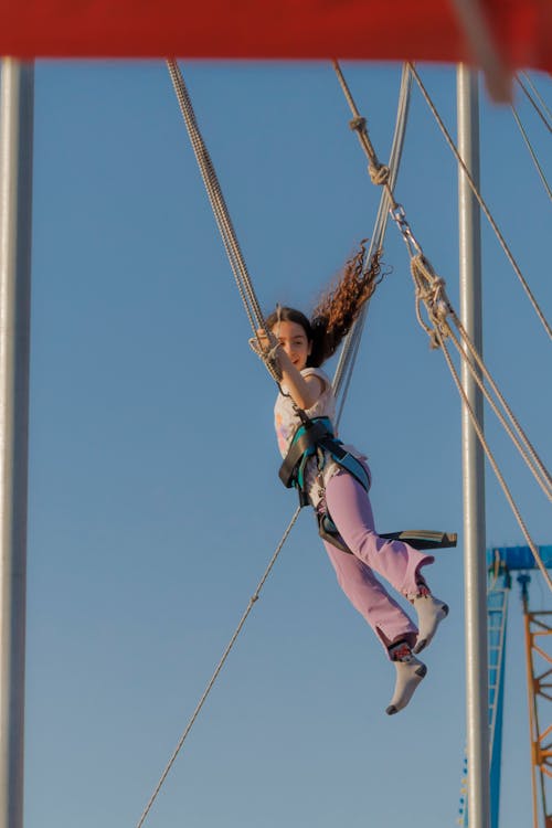 A Girl Jumping on a Bungee Trampoline 