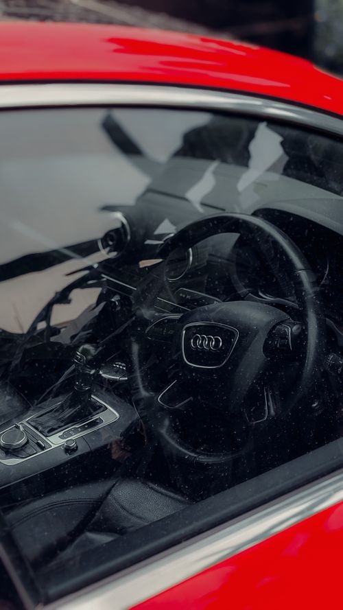 Free High-end car interior view featuring a sleek steering wheel and console. Stock Photo