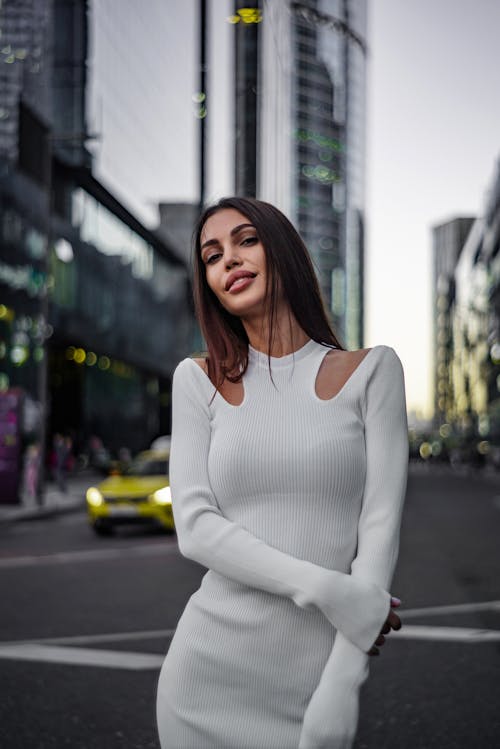 Woman in White Clothes Posing on Street in City