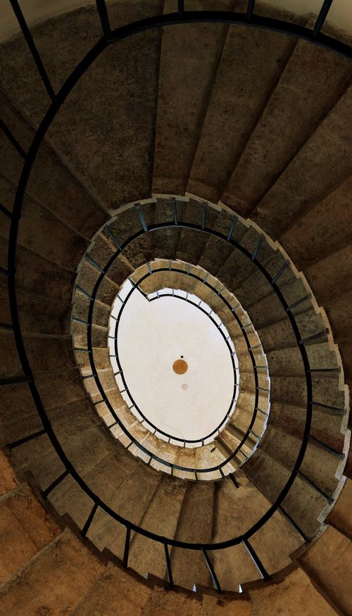 Free Dramatic view of a spiral stone staircase in Venice showcasing classic Italian style. Stock Photo