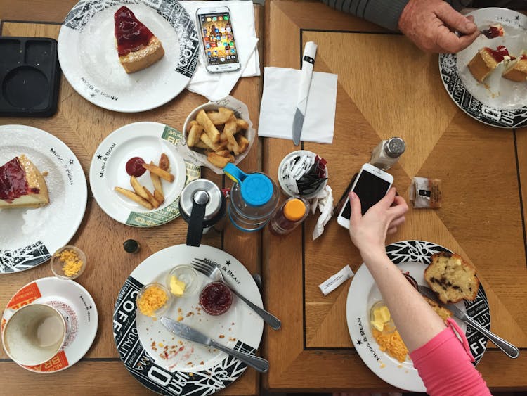 Person Holding Iphone On Table