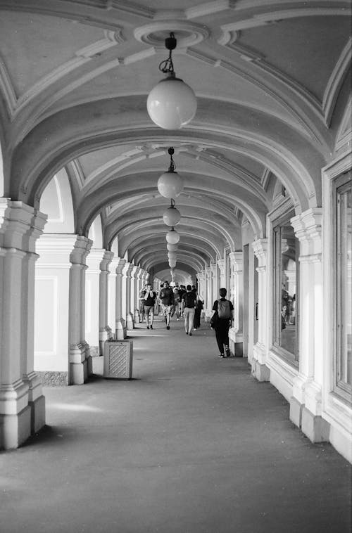 A black and white photo of a long hallway