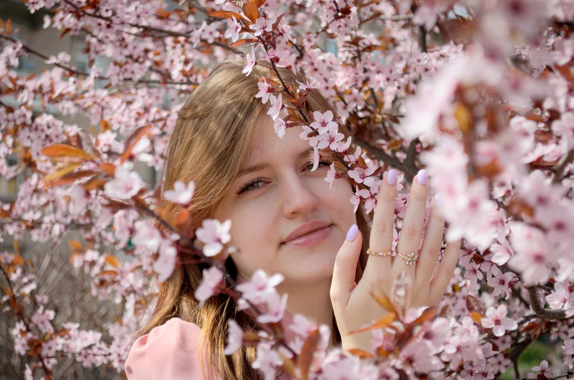 Portrait of a girl in spring flowers with long hair · Free Stock Photo