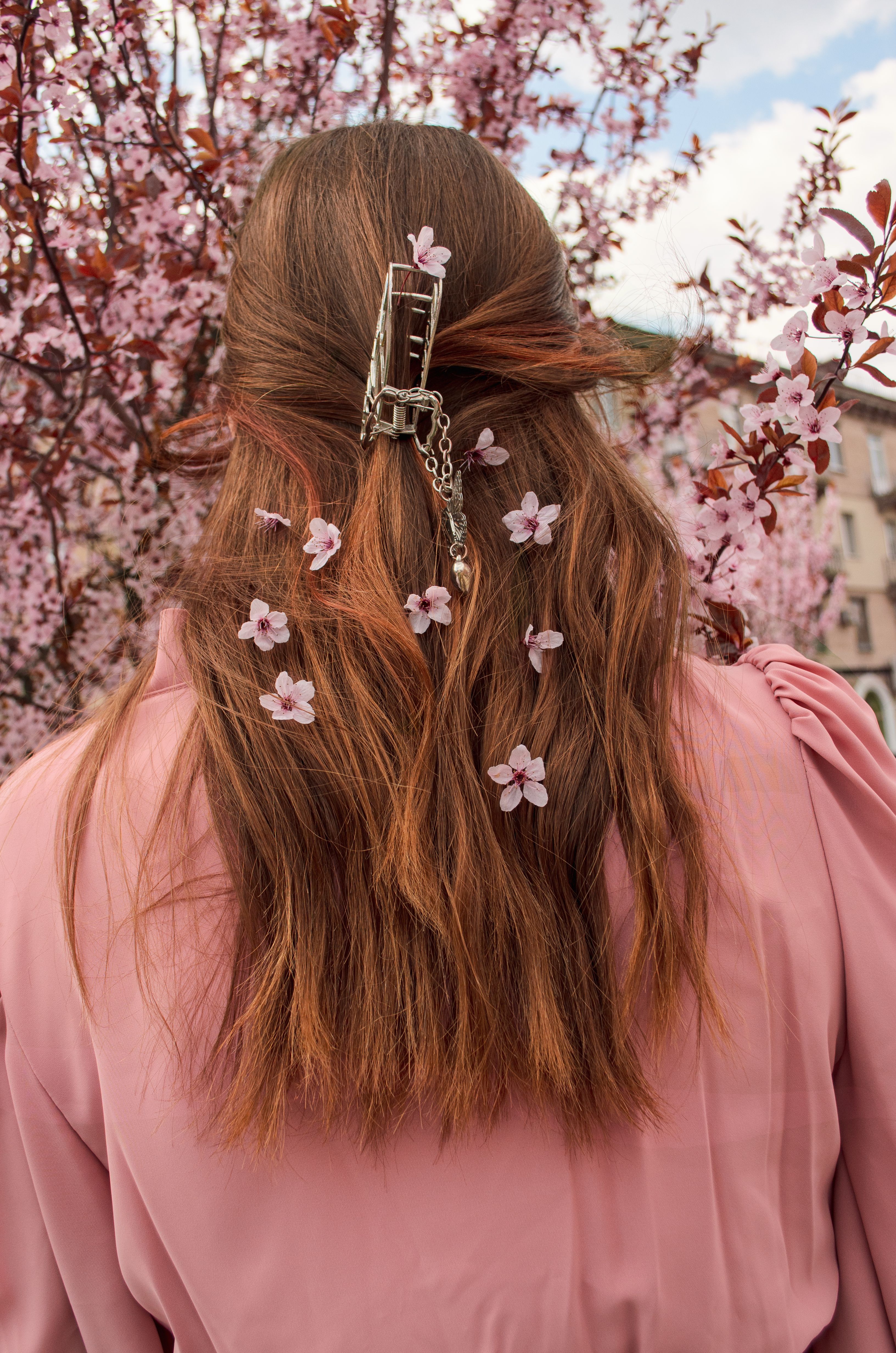 The girl's back is turned in spring flowers · Free Stock Photo
