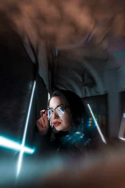 Captivating portrait of a woman with prism effects in her eyewear, creating a unique and artistic look.
