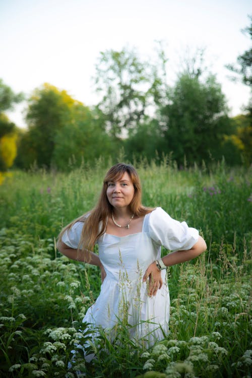 Woman in White Dress on Meadow