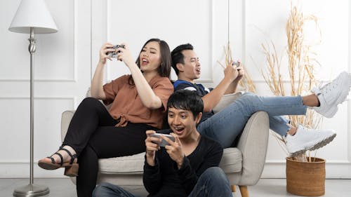 Group of diverse friends playing game on mobile phone