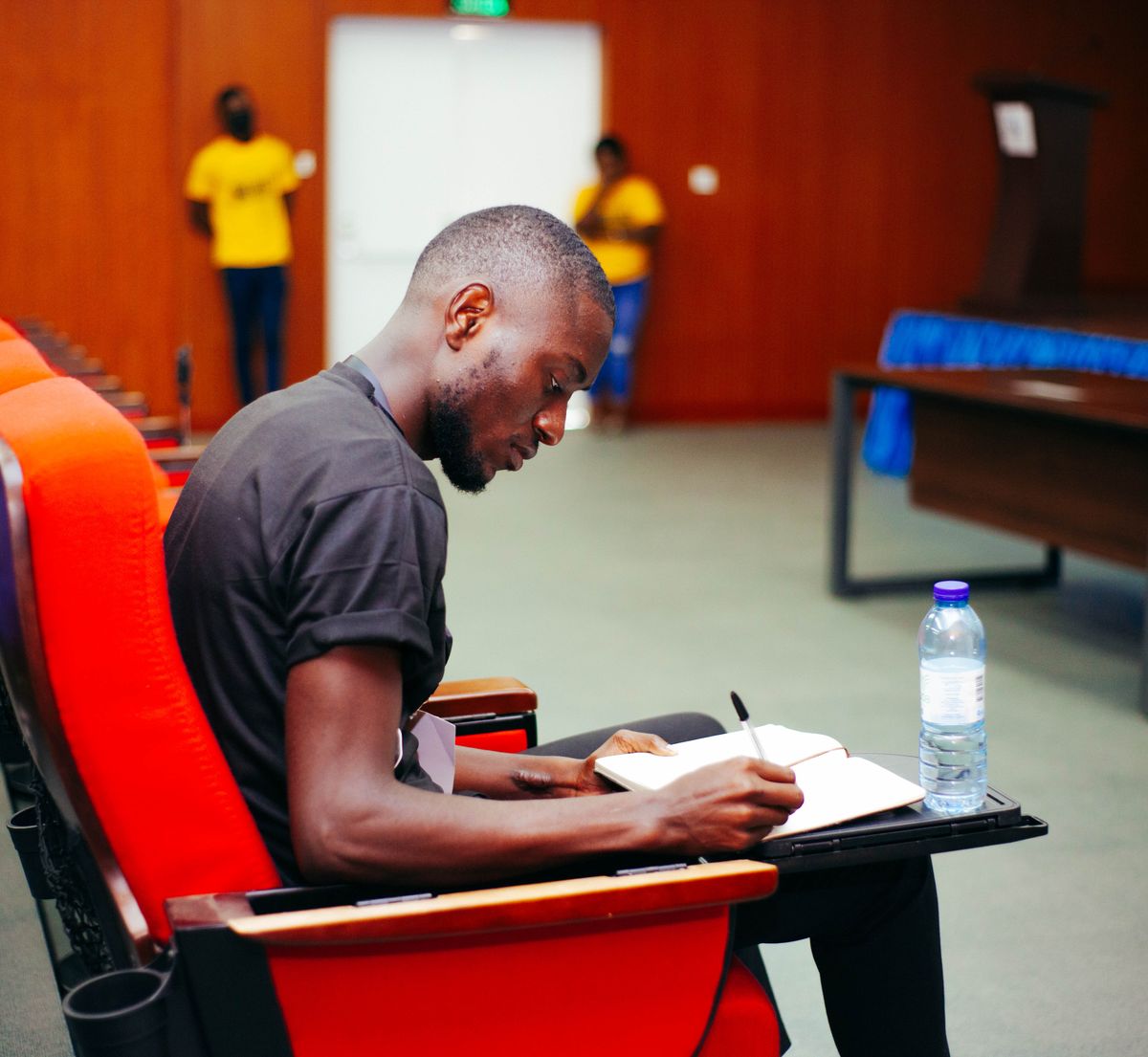 A professional author taking notes during a focused workshop