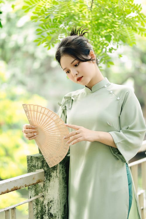 Brunette in Elegant Dress with Fan