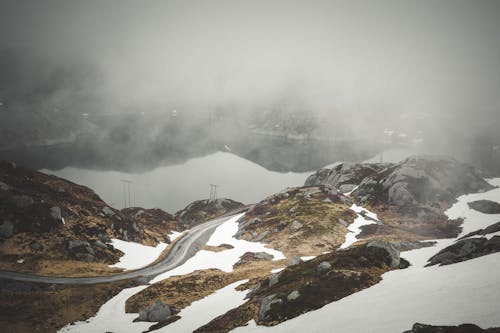 Landscape of a Body of Water in the Valley and Snowcapped Mountains 