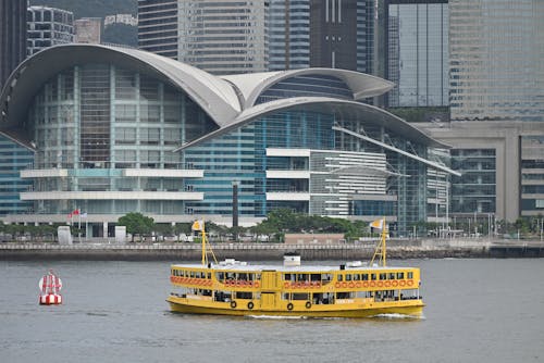 A Yellow Ferry Sailing in the Victoria Harbor in Hong Kong, China 