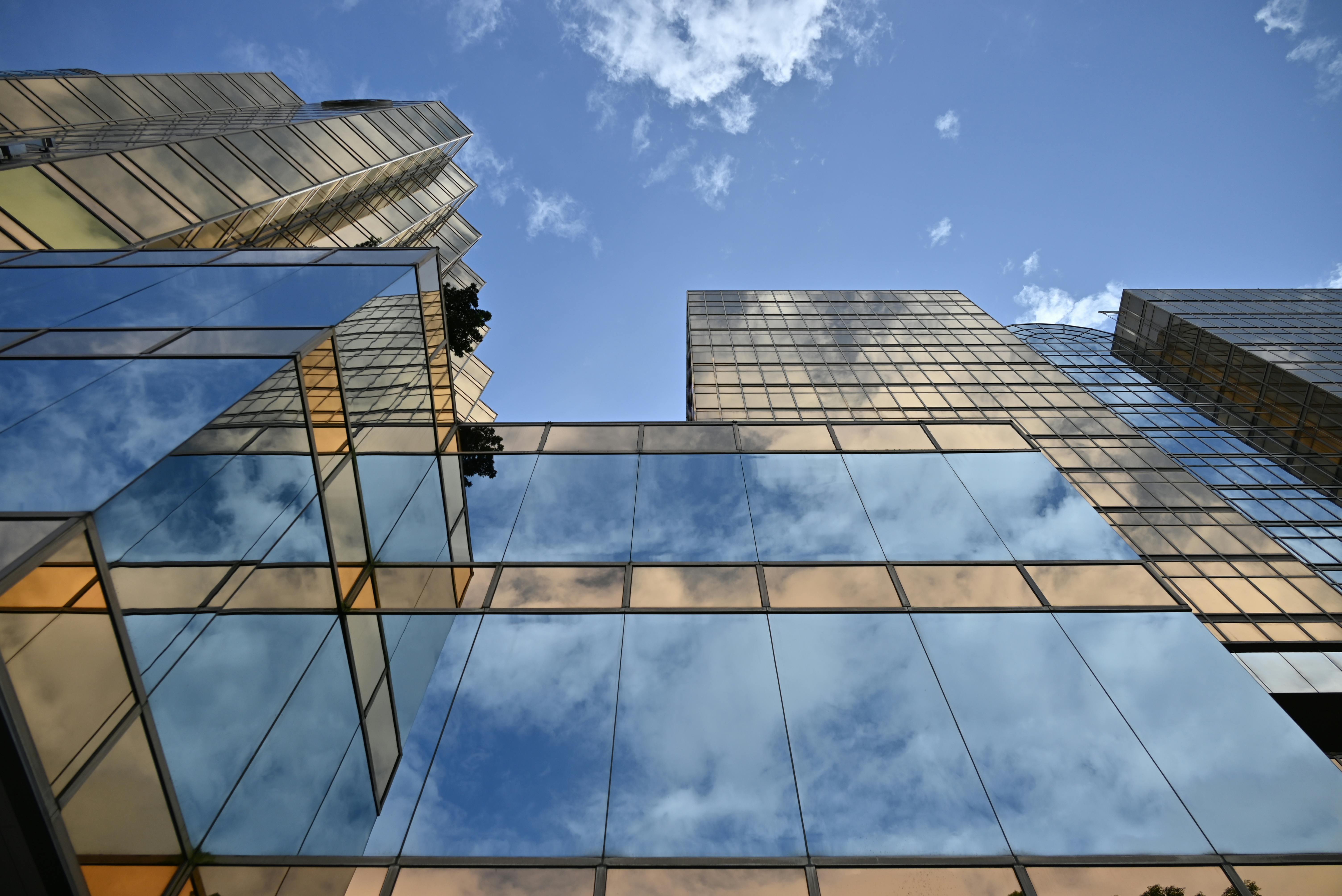 Five Gray Concrete Buildings Under Blue Sky · Free Stock Photo