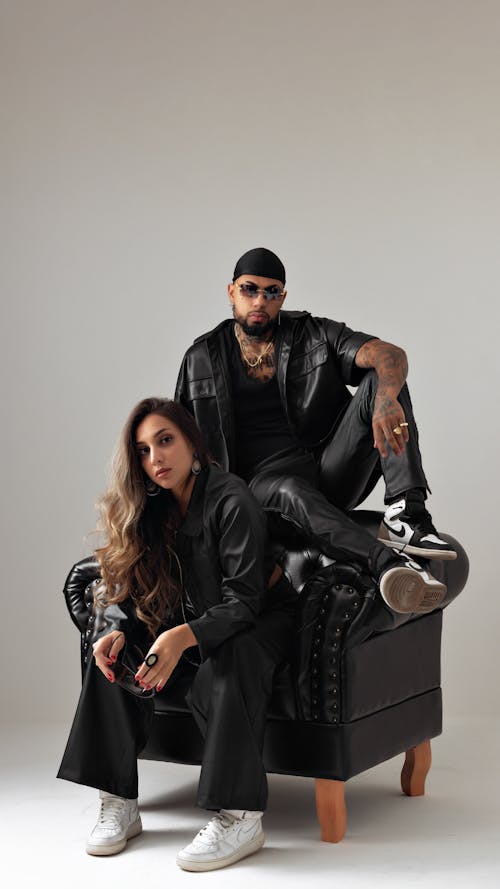 Studio Shot of a Man and Woman in Trendy Streetwear Outfits 