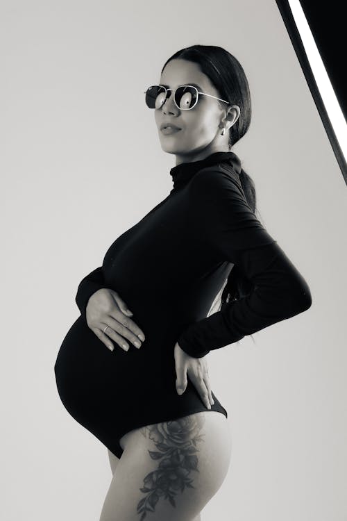 Pregnant Brunette Woman in Black Polo Neck Bodysuit
