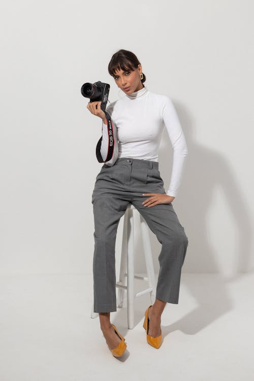 Woman Sitting with Camera on Chair