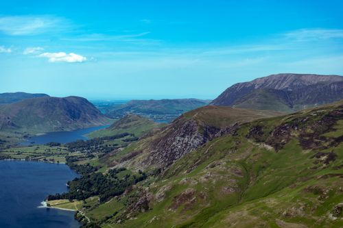 Free A breathtaking aerial view capturing the serene lakes and rolling hills of the Lake District, England. Stock Photo