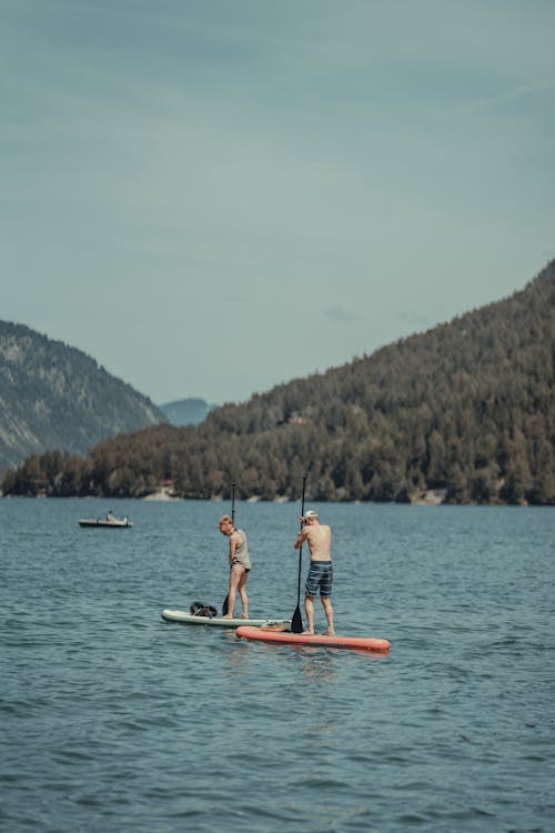 A Man and Woman Paddleboarding 