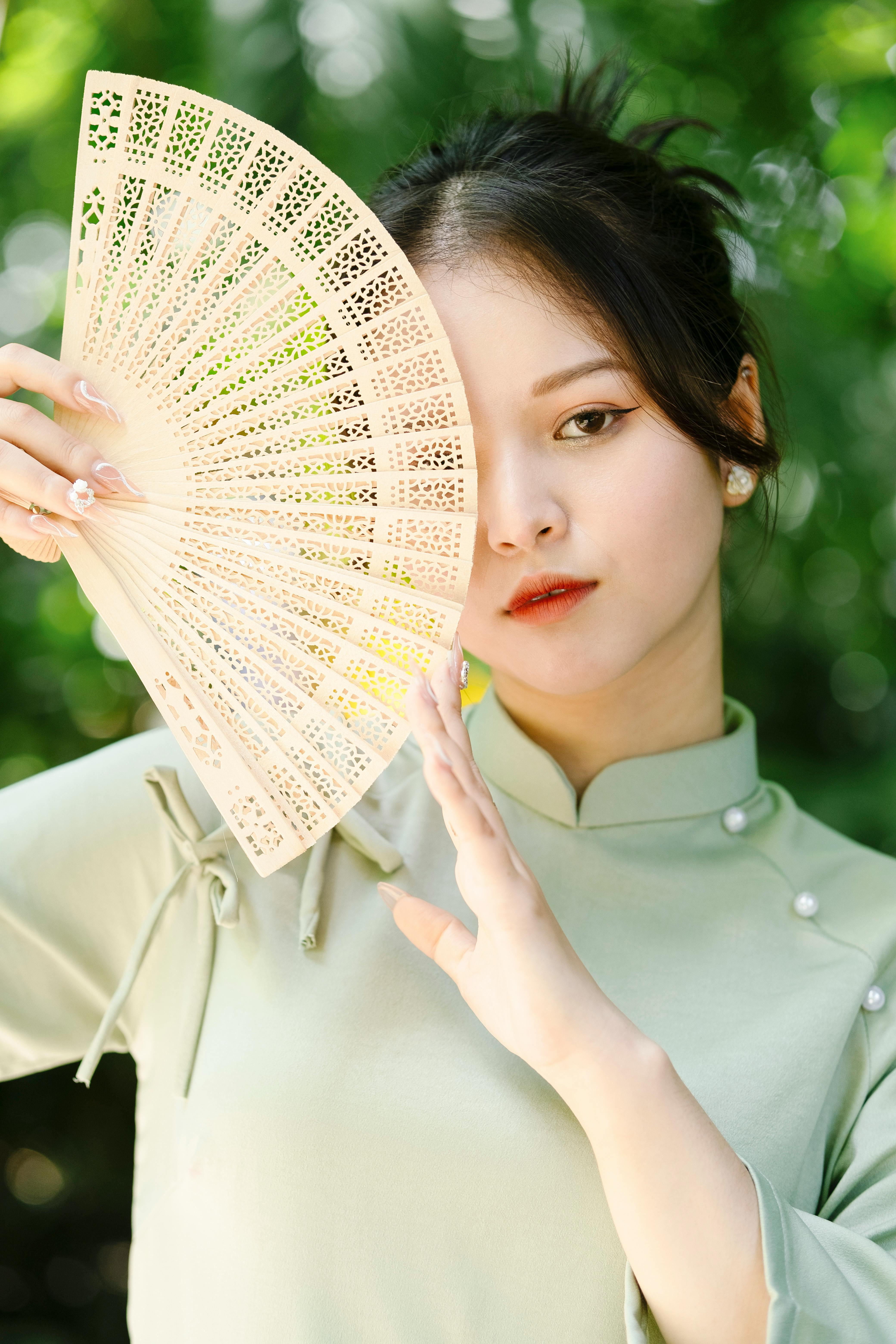 woman holding fan