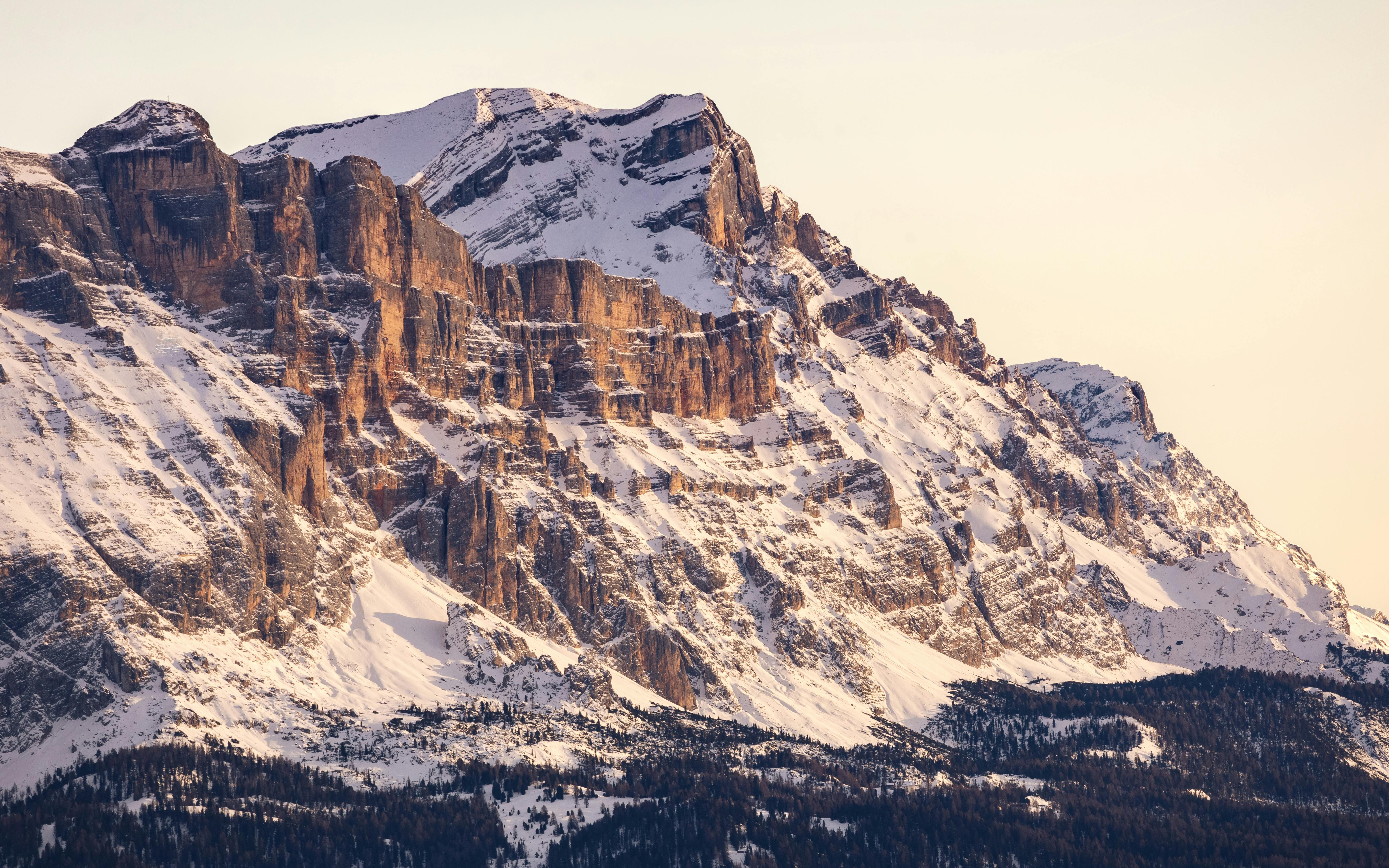 Capture the majestic beauty of snow-covered mountain peaks in the Italian Dolomites at sunset. Perfect for nature and travel enthusiasts.