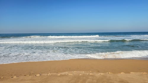 Free Waves Splashing on Sand Beach Stock Photo