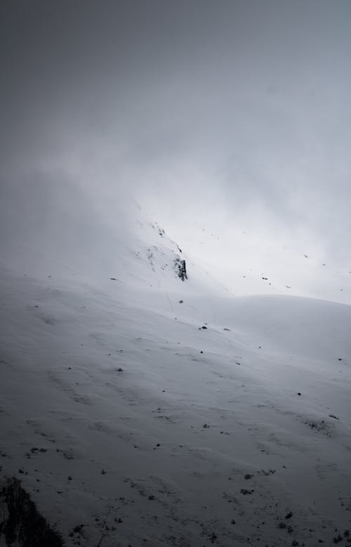 A person is walking up a snowy mountain