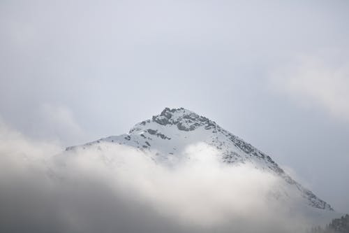 A mountain covered in clouds and fog