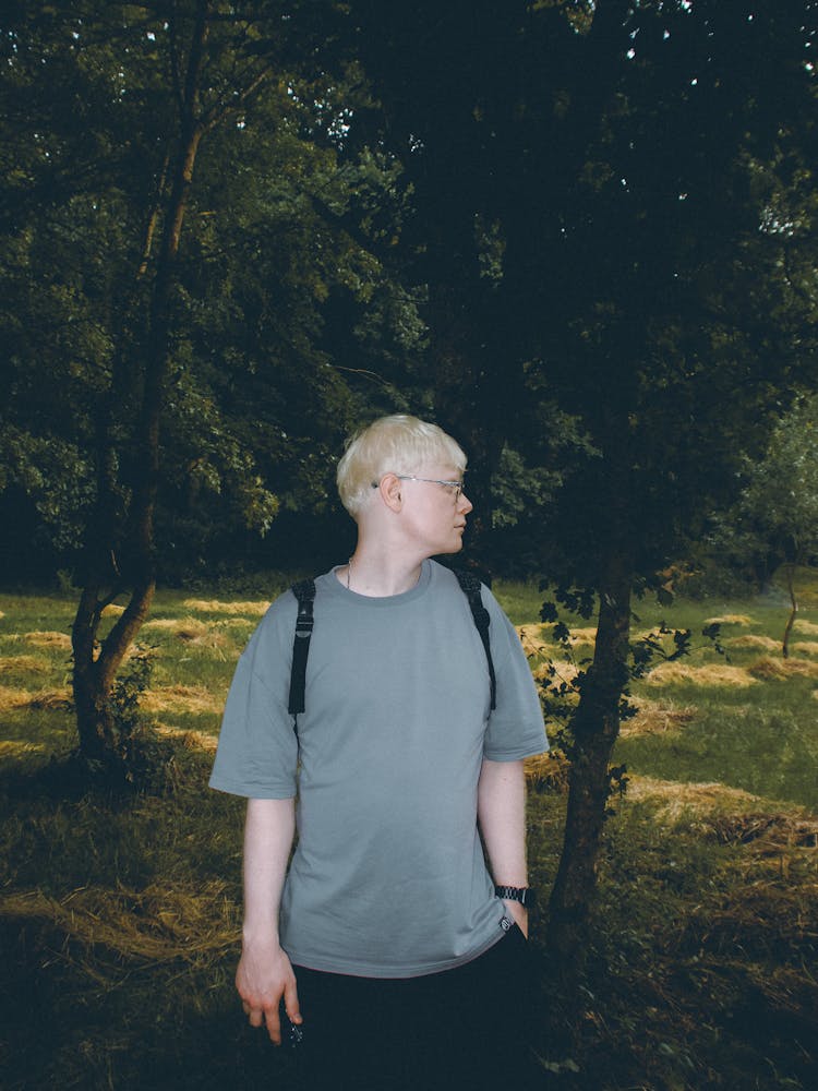 Man Standing By Field With Cut Hay