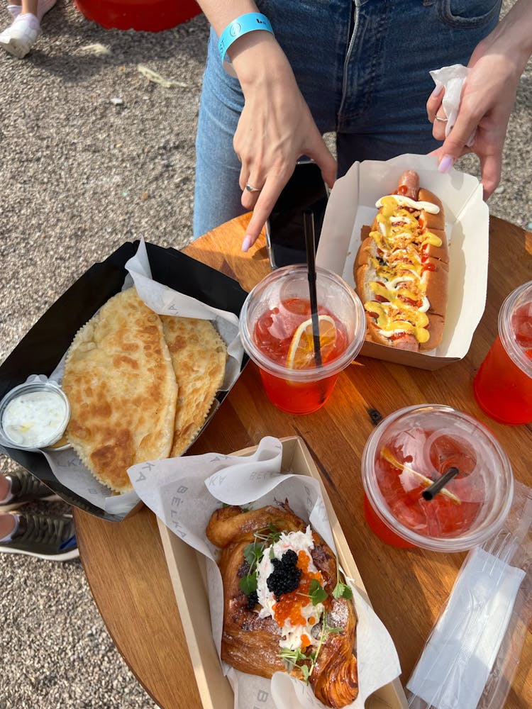 Woman With Takeout Food On Wooden Table