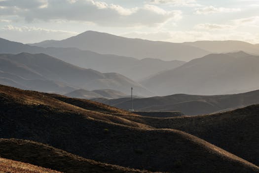 Capture of misty mountains in Mashhad, Iran during a serene day, showcasing natural beauty.