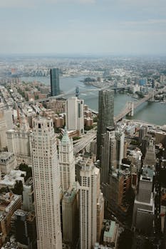Aerial photograph of Manhattan, New York City showcasing skyscrapers and bridges.