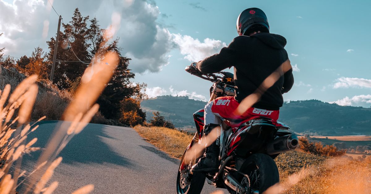 Rural Motorcycle Riding Biker Riding on Motorcycle on Rural Road · Free Stock Photo